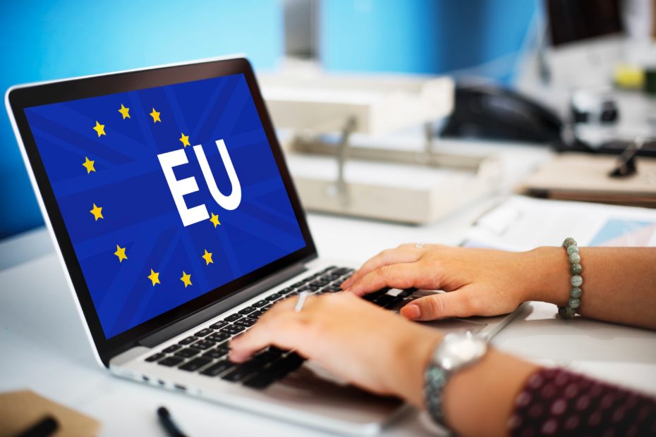 Hands typing on laptop with EU flag overlay representing European analytics compliance